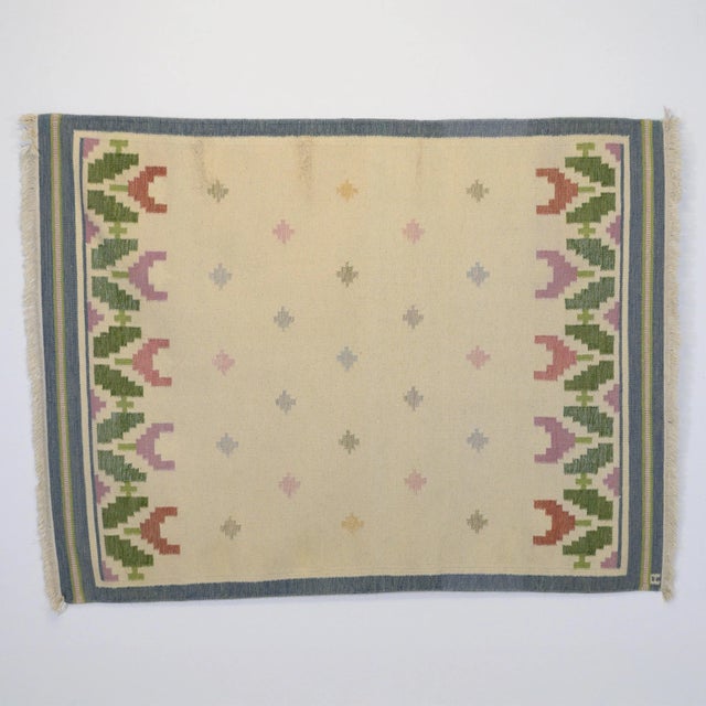 A really nice example of a floral-patterned Swedish kilim in tones of cream, blue and green with hints of pink and purple....