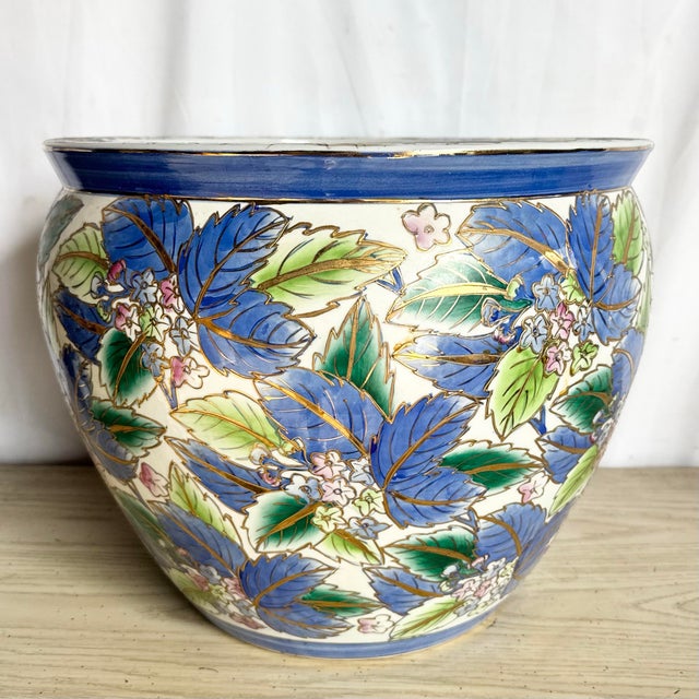 This vintage Chinese porcelain fishbowl showcases a richly hand-painted floral motif rendered in layered shades of cobalt...