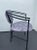 This is a great looking post modern Memphis style set of 4 chairs. They are curved black metal. The geometric upholstery...