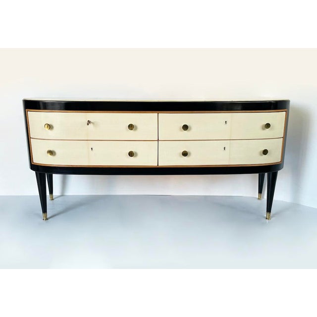An elegant, fully restored, mid-century low chest of drawers. The piece features a black lacquered wooden frame with four...