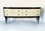 An elegant, fully restored, mid-century low chest of drawers. The piece features a black lacquered wooden frame with four...