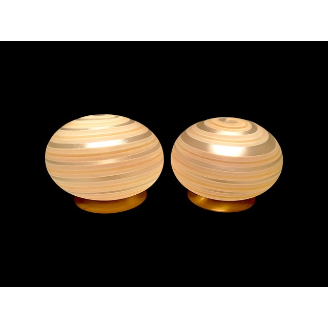 Vintage Murano glass table lamps, dating back to the 1970s, MCM style, featuring a spherical design with a spiral motif....