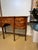 This is a 19th Century English mahogany sideboard. Its design was inspired by the Hepplewhite sideboards from the Regency...