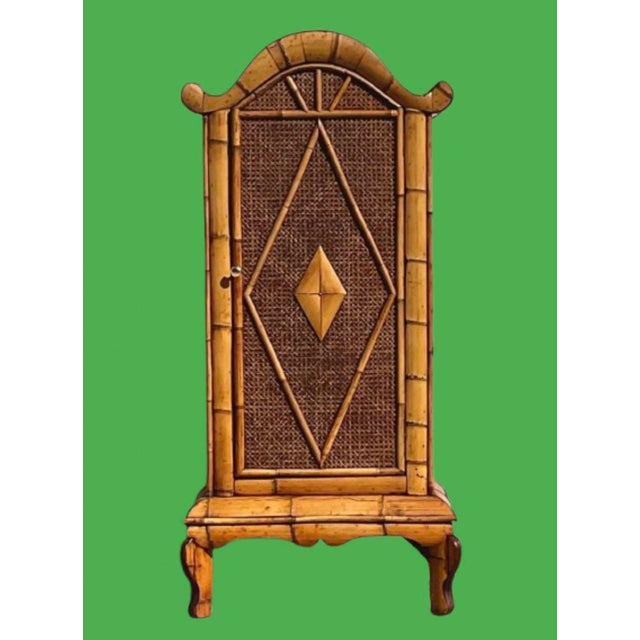 A tropical style cabinet with burnt bamboo finish, the door open to 3 shelves a light piece to move around plus it’s...