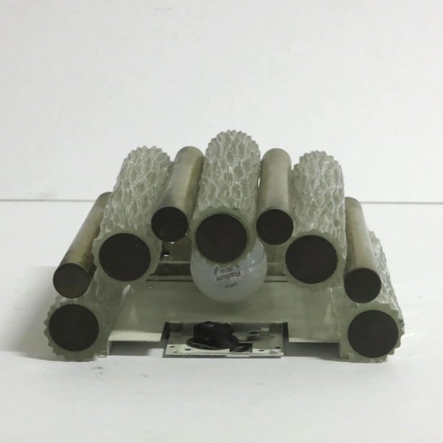 This big wall lamp was made in the 1960s by Kaiser Leuchten. It features five glass light tubes that are each separated by...