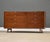 A mid century modern walnut eight drawer designed by George Nelson for Herman Miller with rare aluminum I pulls....