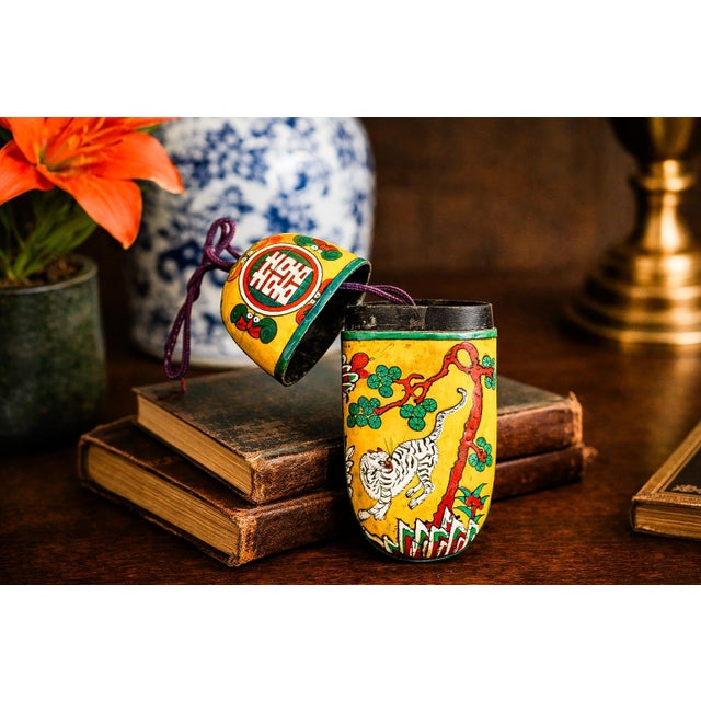 A remarkable example of late Qing Dynasty craftsmanship, this circa 1885 hand-painted Chinese lacquer spectacle case is a...