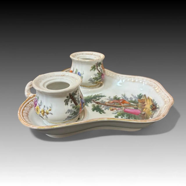 A porcelain double inkwell with plate manufactured by the Helena Wolfsohn company. All three pieces have the copied early...