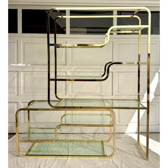 This striking vintage étagère, dating to the late 1970s–1980s, features a sculptural postmodern design with polished...