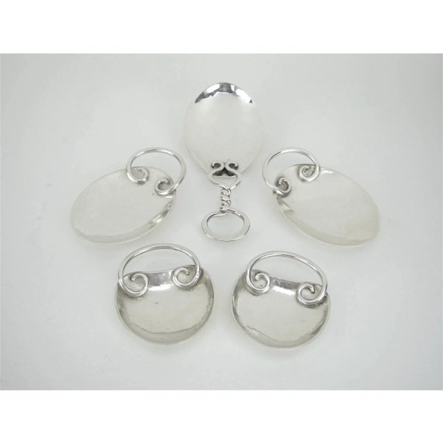 A set of Arts and Crafts spoons in hand-wrought silver by Marie Zimmermann (1879-1972), a noted American metalsmith,...