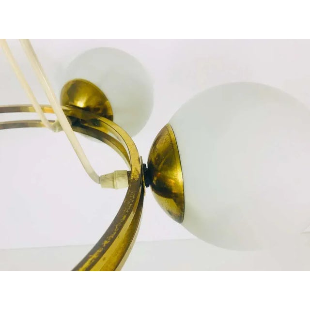 A midcentury Kaiser chandelier made in Germany in the 1960s. It is fascinating with its Space Age design and six opaline...