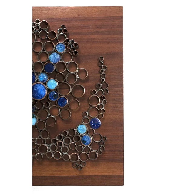 Beautiful wall sculpture on teak board with copper rings and enamel. In a fair condition with white corrosion on the...