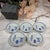 A set of Japanese-made blue and white porcelain plates, shaped like chrysanthemum petals, with blue and white patterns...