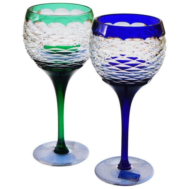 Stunning pair of midcentury Hungarian clear, green and blue crystal stems. Elegantly hand-cut with ornate stems and...