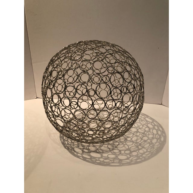 From the 1960’s, this pair of wire spheres were meticulously created by the artist by soldering each “circle”...