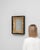 This 1980s French mirror pairs a gilded frame with a sleek black wooden display case. Scrolling foliage and floral relief...