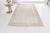 This is a vintage Turkish Oushak rug from the Mid 20th Century. The piece was hand-knotted.