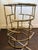 Chinoiserie meets Hollywood Regency in this gilt faux bamboo accent table. Features a circular glass top and an open,...