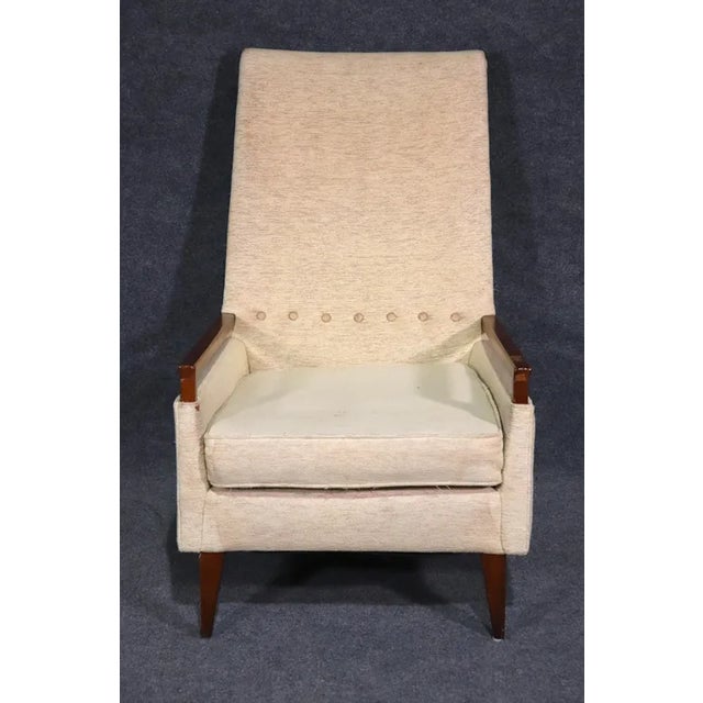 Unique vintage modern lounge chair with exposed wood arms and tufted back. Great design with Mid-Century Modern lines....