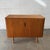 A vintage Danish teak sideboard with a compact apartment-friendly scale and clean cabinet front. The piece has two doors...