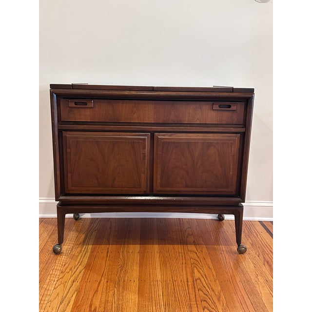 A stunning example of mid-century modern design, this vintage dry bar is as functional as it is elegant. Crafted in rich...