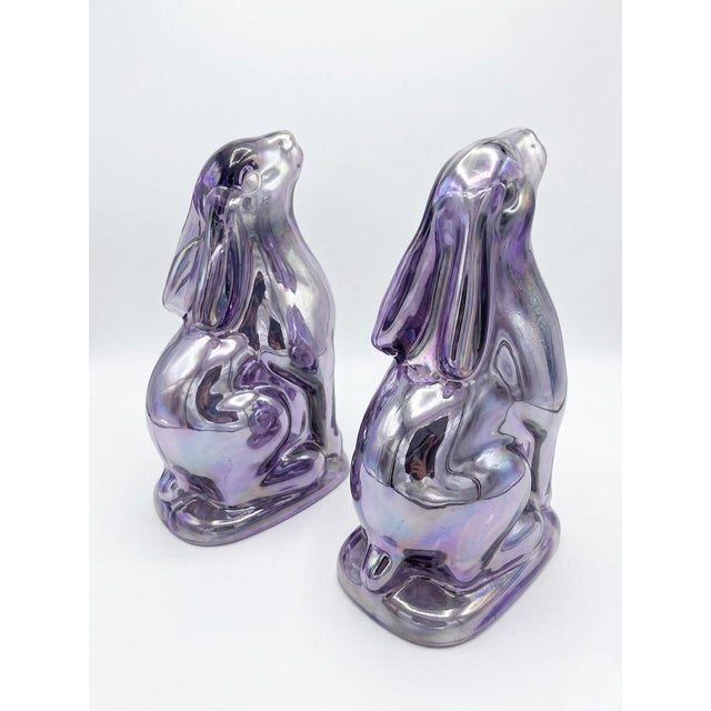 Add a touch of playful sophistication to your shelves with this striking pair of vintage glass bunny figurines. Exuding an...