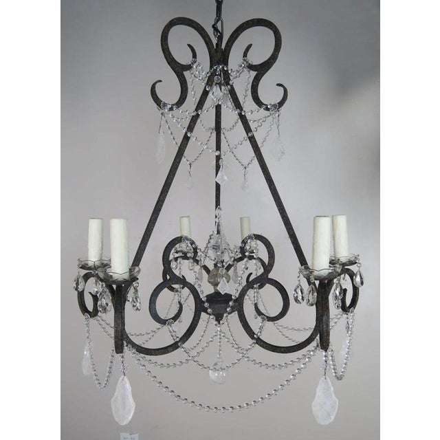 20th century hand wrought iron six light chandelier adorned with rock crystal pendulum shaped drops and garlands of...
