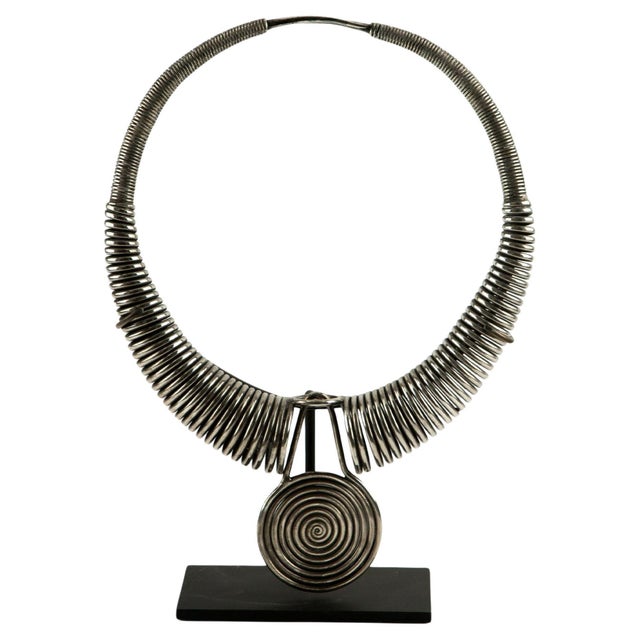 An impressive traditional Miao silver pectoral necklace, hand-forged from coiled silver wire with a large central spiral...