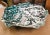 Vintage handmade white dish or plate with a splattered design in teal, pale pink and black with a jagged edge. This color...
