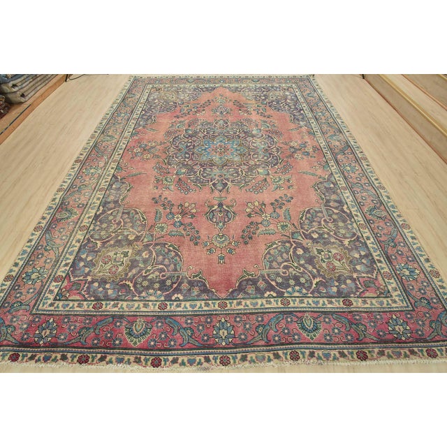 An authentic vintage traditional Tabriz rug hand-knotted with fine wool and natural dyes. This oriental rug features a...