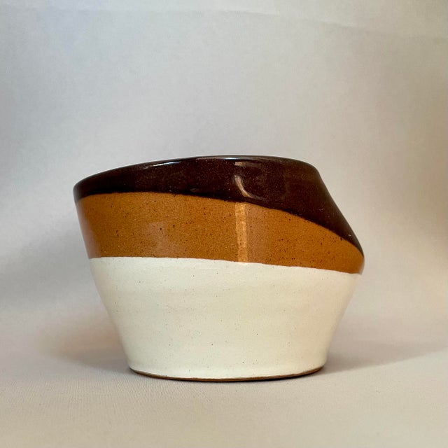 Signed by ULUV, made in Czechoslovakia and dating to the 1970s, this sculptural ceramic ashtray features an asymmetric rim...