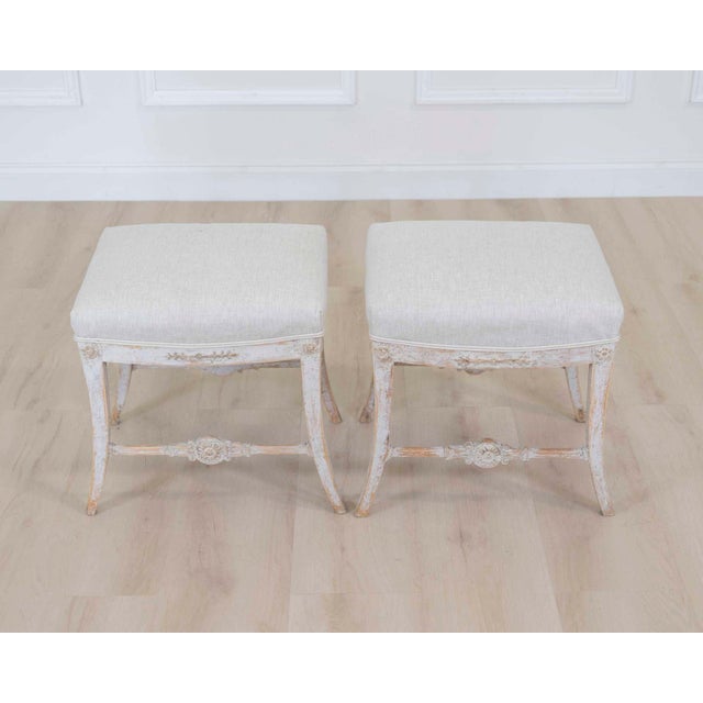 Made in Sweden around 1810, this pair of Gustavian stools shows the restrained neoclassical character of the style. The...
