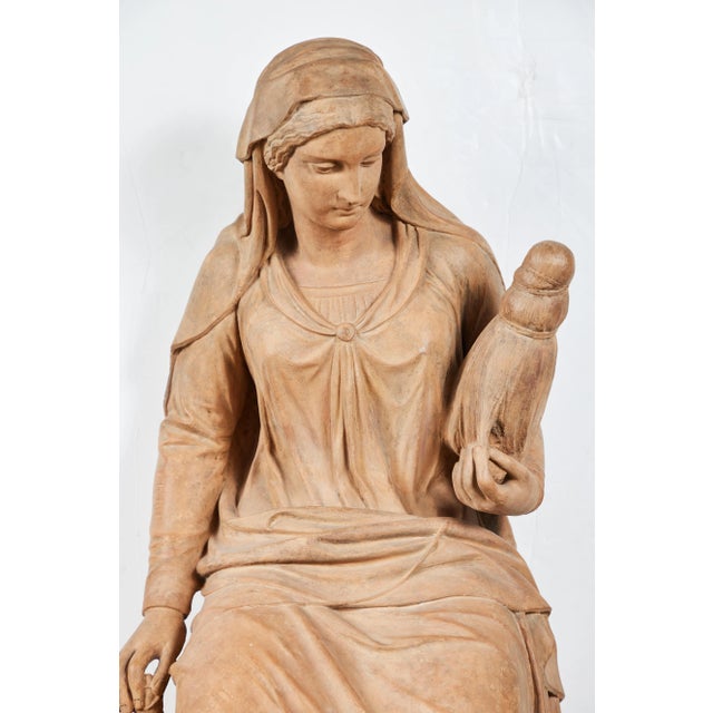 A signed, dated, 1855 terracotta, classical style sculpture of the robed figure of Fate holding the thread of life by...