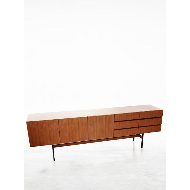 Add a touch of timeless European design to your home with this vintage mid-century teak sideboard by Musterring Möbel,...