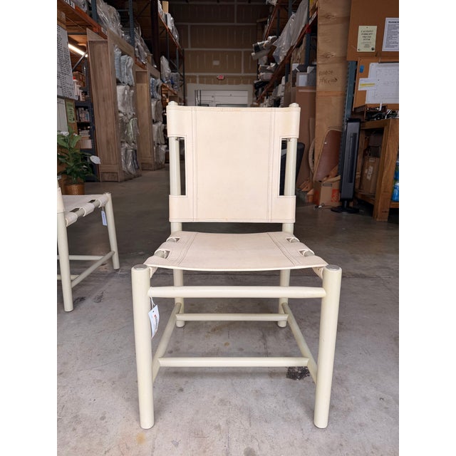 Add timeless sophistication to your dining space with this contemporary dining chair, upholstered in luxurious cashew...