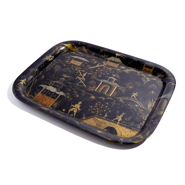 A beautifully rendered English tole tea tray, painted with an extensive chinoiserie landscape in gilt and bronze powder...