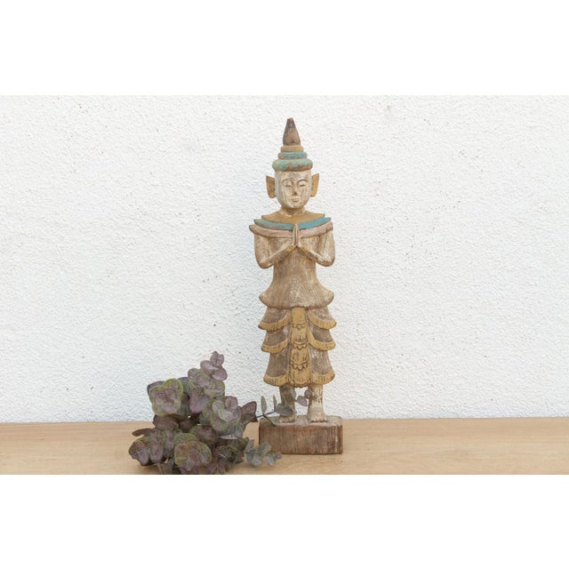 A graceful example of Burmese religious folk art, this standing figure represents a Nat spirit or a celestial attendant in...