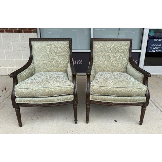 This pair of Ethan Allen Giselle Bergère Chairs combines carved dark wood frames with luxurious blue-and-gold cut-velvet...