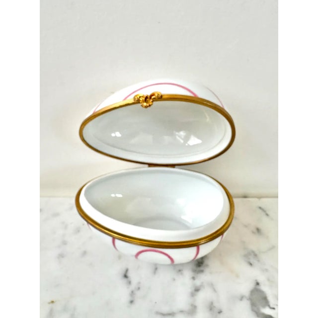 Lovely vintage Limoges France handpainted pink striped porcelain egg trinket box with brass closure. Great for storing...