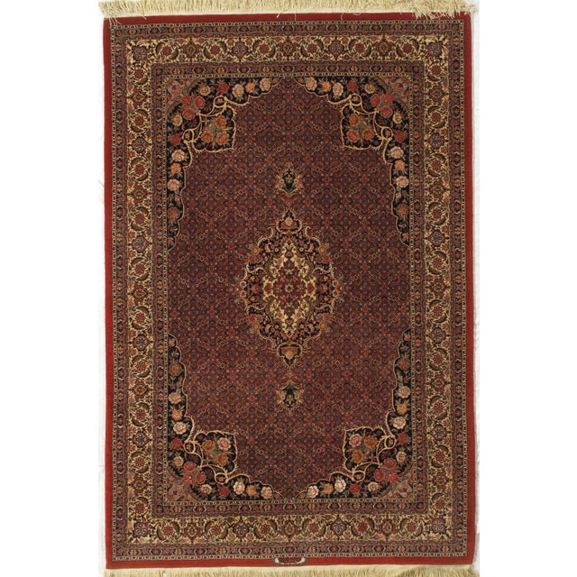 Antique hand-knotted Persian Bidjar wool rug with a red field featuring an allover Herati pattern and a central medallion....