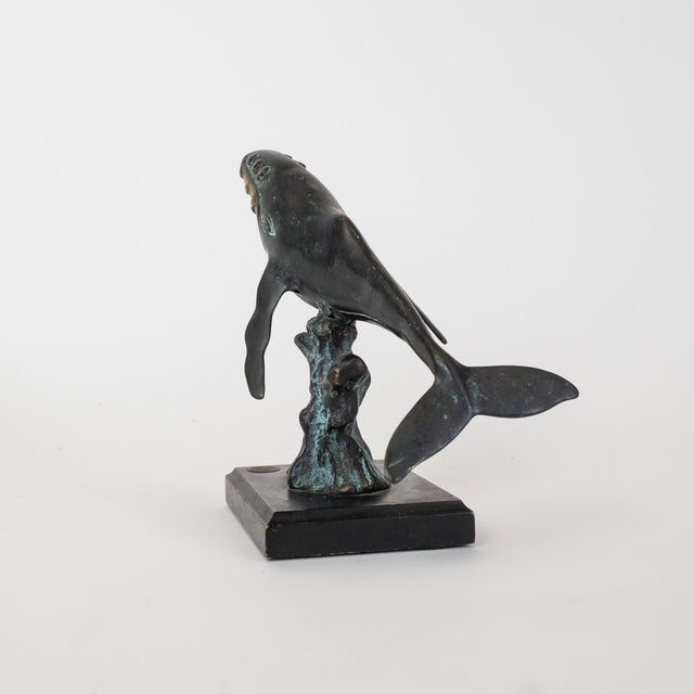 A dynamic SPI (San Pacific International) humpback whale sculpture, finished in a rich bronze patina, dating to the late...