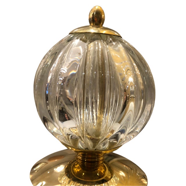 This table lamp is made of white glass with a satin finish. Its organic shape, with an oval design, lends an elegant and...