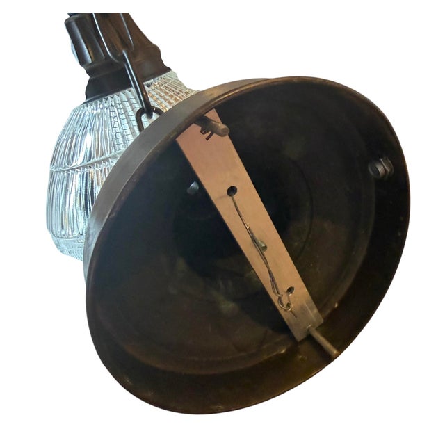 This is a pair of antique industrial Holophane style pendant lights, featuring clear prismatic, reeded glass shades...