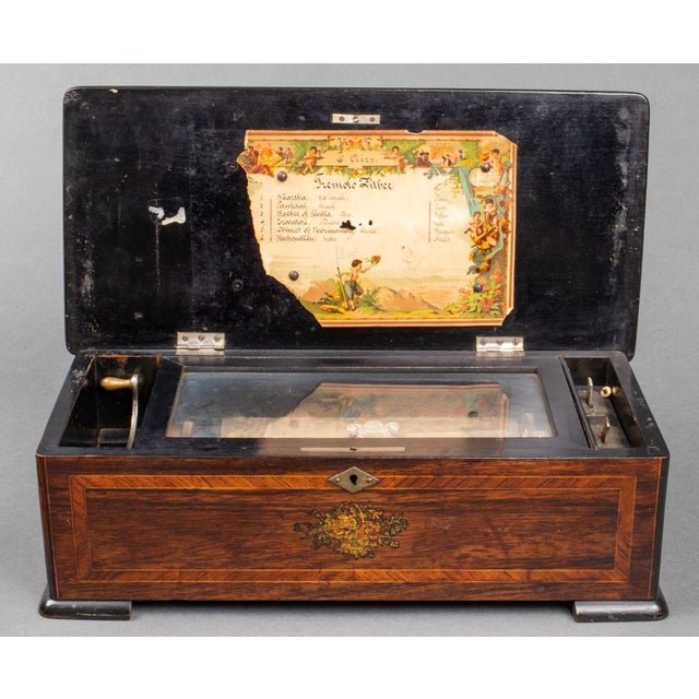 Swiss Cylinder "6-Airs" Marquetry Music Box, the case with inlaid flower decoration on hinged lid, partial original list...