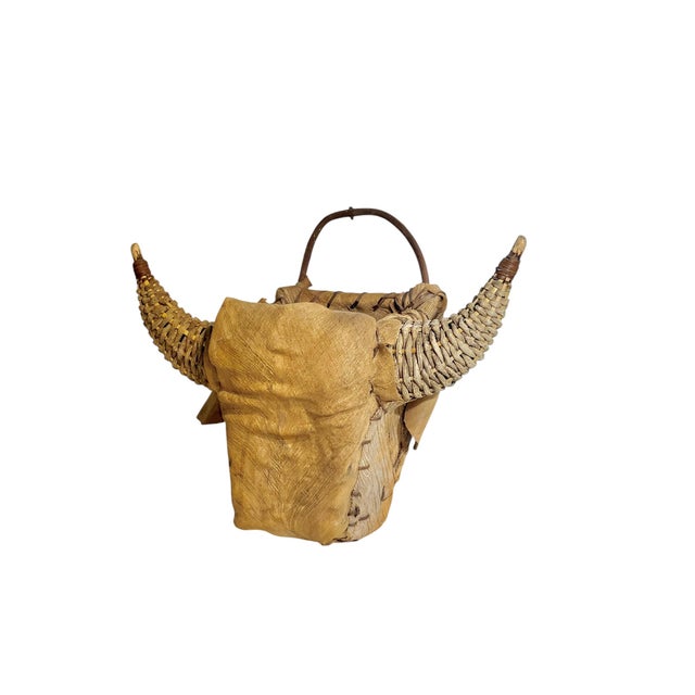 A striking vintage woven bull head wall sculpture, crafted in natural rattan with beautifully curved “horns” and rich...
