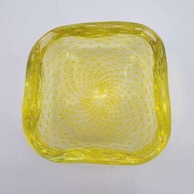 A mesmerizing mid-century treasure, this Murano glass bowl by Carlo Scarpa for Venini showcases the intricate Bullicante...