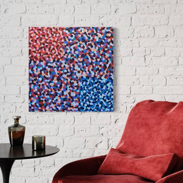 Overlapping dots of navy, cobalt, periwinkle, coral red, pink, peach and plum fill the square, the warm colors gathered in...