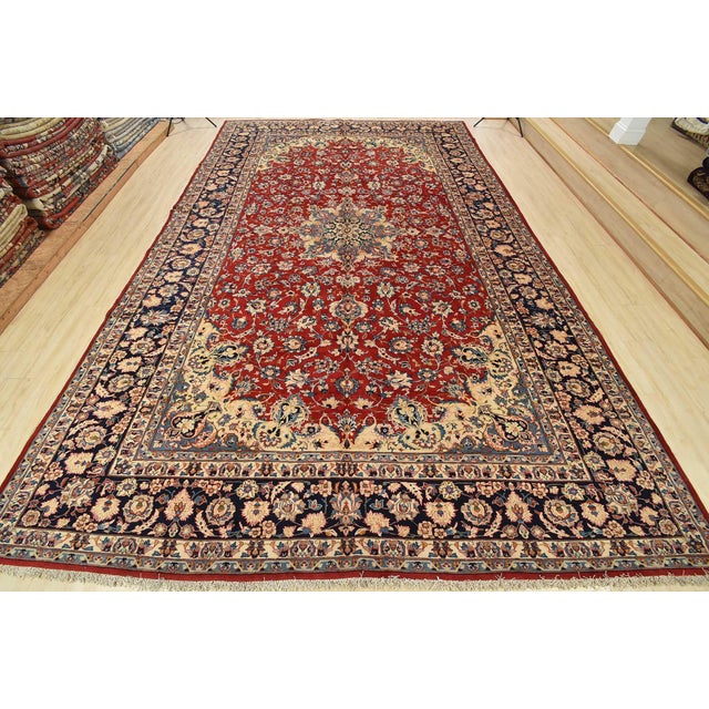 An authentic vintage traditional Najafabad rug hand-knotted with fine wool and natural dyes. This rug features a central...