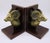 A pair of vintage brass ram's head bookends on lacquered wood bases with brass trim inlay. Unmarked, dated to mid-20th...