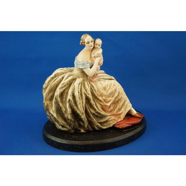 A magnificent, richly glazed ceramic sculpture, entirely hand-decorated in glazed stoneware, depicting a lady in a full...